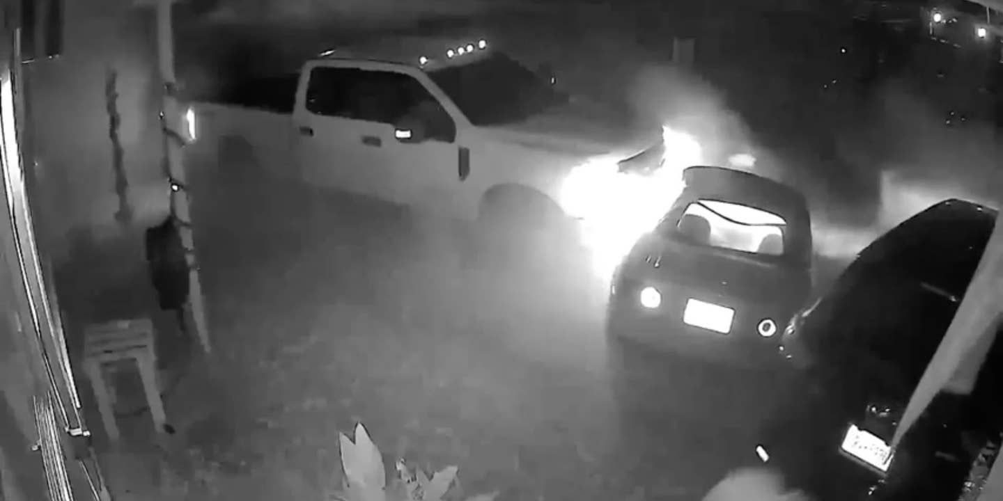 A Ford Super Duty captured on security camera destroying a couple's cars after nearly killing them